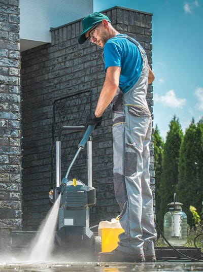 man with pressure washer