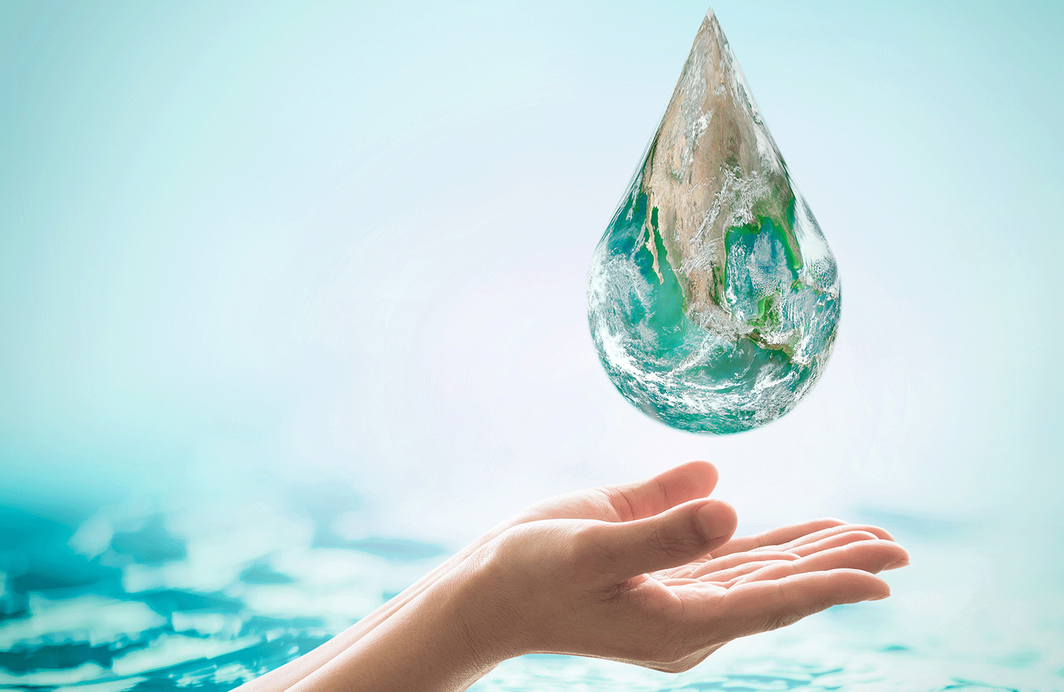 hand catching a huge droplet of water with reflection of the earth | environmentally friendly pressure washing