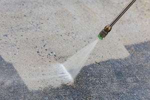 close up of outdoor floor cleaning with high pressure water jet | soft wash house