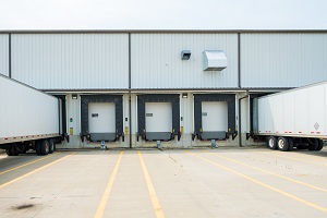 warehouse building with 53 foot dry van trailers backed into docking doors | loading dock cleaning