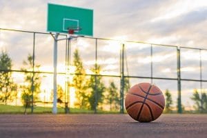 basketball in a basketball court at sunset | keep HOA common areas clean