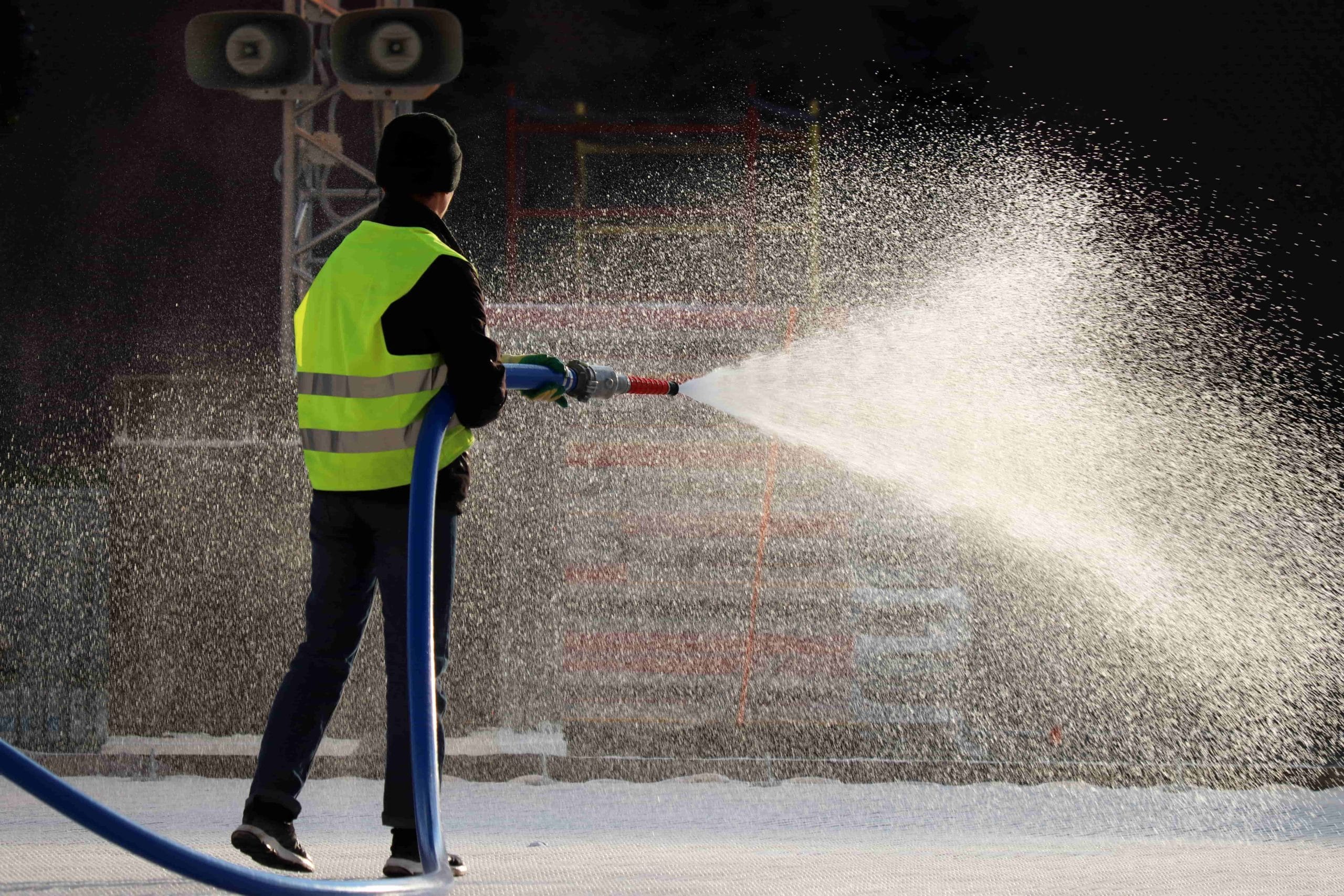 man using a jet spray | keep HOA common areas clean